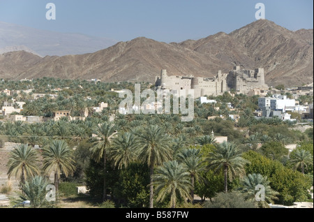 Fort in palmery on edge of modern oasis town, Bahla, Oman, Middle East Stock Photo