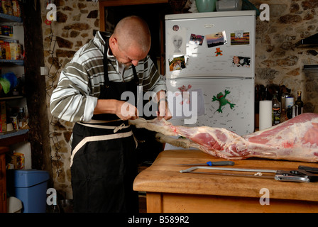 Stock photo of a man butchering a lamb Stock Photo