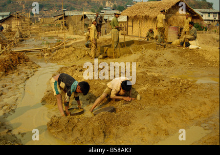 Children sieving and washing small gems from mine waste Mogok ruby mines near Mandalay Myanmar Burma Asia Stock Photo