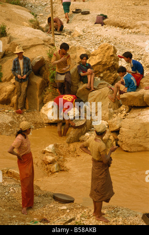 Children sieving and washing small gems from stream below mine Mogok ruby mines near Mandalay Myanmar Burma Asia Stock Photo