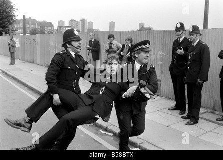 Lewisham Riot 1977: An injured policeman is carried away from the Lewisham riot by colleagues. The riot was sparked by a National Front march through the centre of town, which was confronted by a left wing counter demonstration. August 1977 77-04357-014 Stock Photo