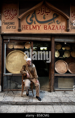 Shop owner relaxes in the great bazaar of Khan al-Khalili, Cairo, Egypt, Africa Stock Photo