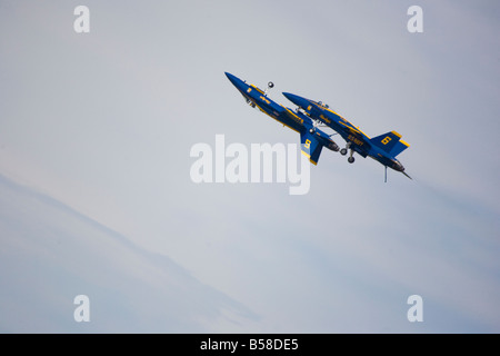 The elite US Navy Blue Angels speed in formation at hundreds of miles per hour above Andrews Air Force Base, Maryland, USA.