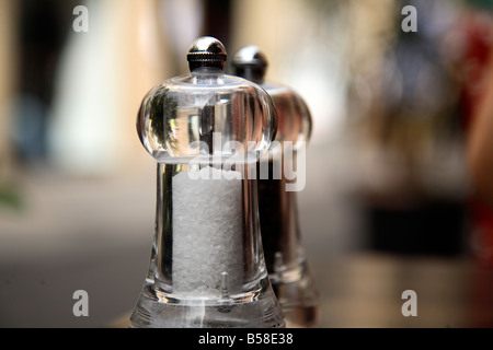 Salt and pepper shakers on a table Stock Photo