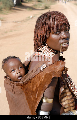 Woman of the Hamar tribe carrying child on her back, Omo Valley Stock ...