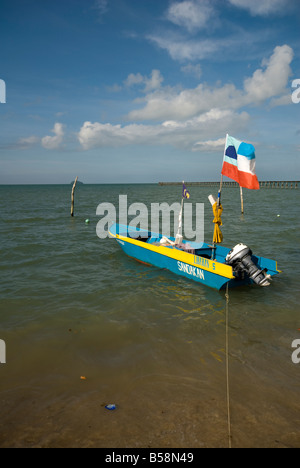 Small boat in South China Sea with flag and blue skies Stock Photo