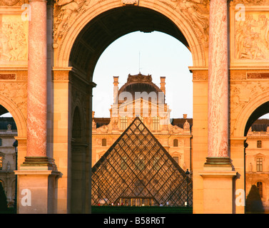 The Pyramide and Palais du Louvre seen through the Arc de Triomphe du Carousel Musee du Lourve Paris France Europe Stock Photo