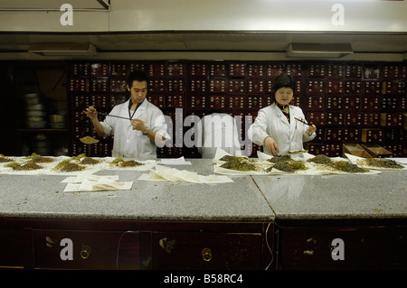 A herbalist prepares an order for a client in Tong Ren Tang, the oldest pharmacy in Beijing.