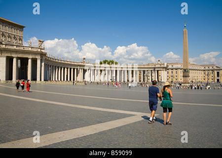 Tourists, obelisk and colonnade, Saint Peter’s Square, Piazza San Pietro, Vatican City, Rome, Italy Stock Photo