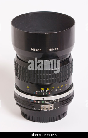 A Nikon 85mm f2 ai Nikkor telephoto manual focus lens with hs-10 lens hood attatched for Nikon 35mm slr film cameras Stock Photo