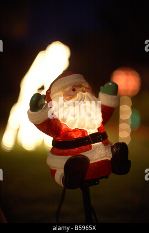 Illuminated christmas light decorations with Father Christmas or Santa Claus outside a house in Queensland QLD Australia Stock Photo