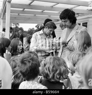 Polo: Jimmy Edwards captained the 'Whocko' polo team that was beaten by 'The Troubleshooters' at Ham Polo Club. Non-playing captain of the 'Trouble-shooters' team, Ray Barrett and John Alderton of 'Please Sir, sign autographs for fans. July 1970 70-6886-001; Stock Photo