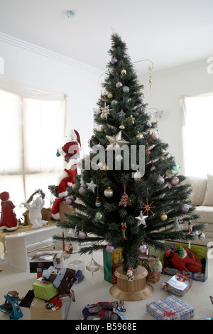 Christmas tree with decorations and presents in daytime living room in Brisbane Queensland QLD Australia Stock Photo