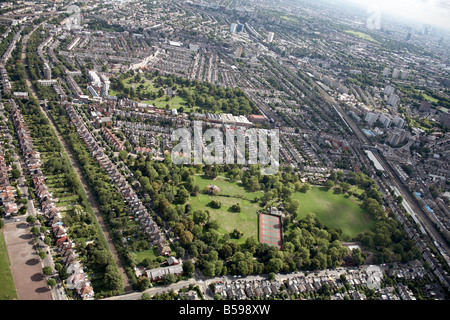 Aerial view north east of Queens Park tennis courts Willesden Lane Cemetery railway line suburban houses tower blocks London NW6 Stock Photo