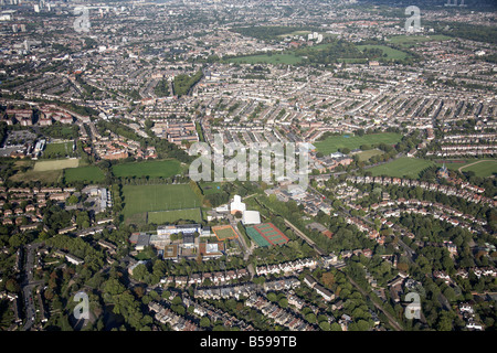 Aerial view north east of Dulwich High School playing fields tennis courts suburban houses Peckham Rye Common London SE22 SE15 Stock Photo