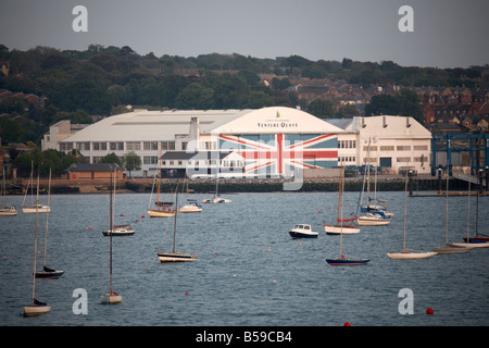 Waterfront VEnture quays shipyard buildings with boats in evening light on the Solent East Cowes Isle of Wight England UK Stock Photo