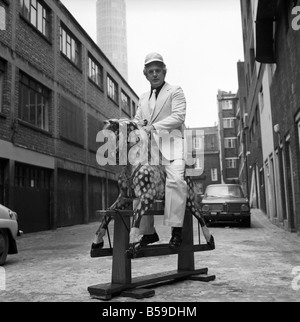 Wrestler Jackie Pallo poses with a rocking horse. &#13;&#10;February 1975 &#13;&#10;75-01087 Stock Photo