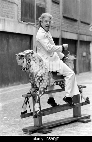 Wrestler Jackie Pallo poses with a rocking horse. &#13;&#10;February 1975 &#13;&#10;75-01087-006 Stock Photo