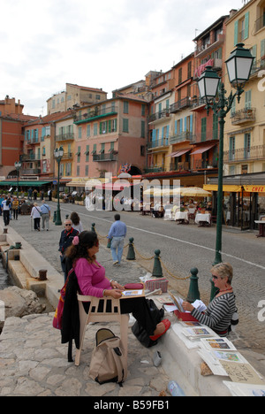 A female artist selling her work in Villefranche in the South of France Stock Photo