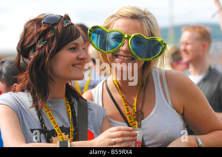 Teenage female fans watch live bands at the T in The Park Music festival Balado, Kinross, Scotland. Stock Photo