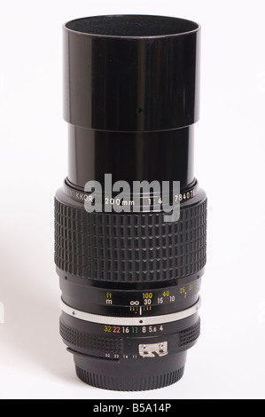 A Nikon 200mm f4 ai Nikkor telephoto manual focus lens with built in hood for Nikon 35mm slr film cameras Stock Photo