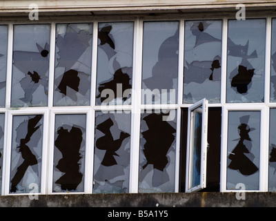 Broken windows at an old derelict factory Stock Photo