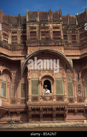 Guard sitting by window City Palace Udaipur Rajasthan state India Asia Stock Photo