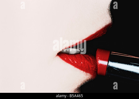 Woman Putting On Lipstick Stock Photo