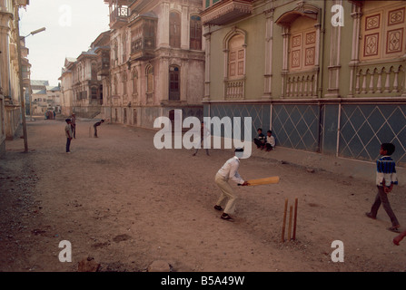 Children play cricket in the street Sidpur India Asia Stock Photo