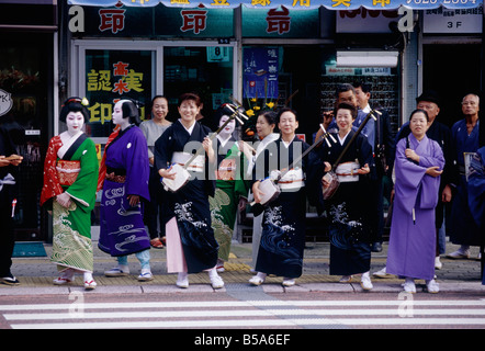 Okunchi religious festival Parade Women in traditional make up with stringed instruments NAGASAKI KYUSHU ISLAND JAPAN Stock Photo