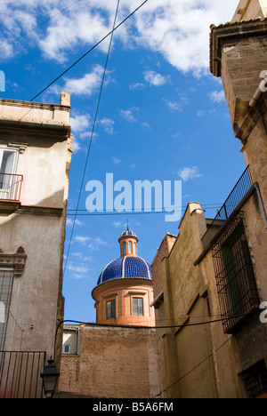 Blue ceramic tiled church dome looking out over rooftops in the old historical centre of El Carmen in Valencia Spain Stock Photo