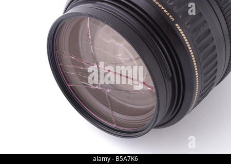 Shattered UV filter fitted on camera lens on white background Stock Photo