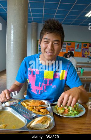 Teenage boy student having formal healthy balanced lunch in school canteen Stock Photo