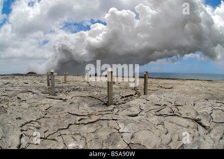Abandoned structure and hot flow Waikupanaha ocean entry lava flow area Stock Photo