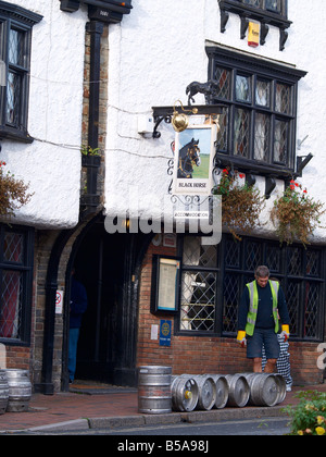 Drayman delivering barrels of beer to The Black Horse public house in Great Torrington, Devon Stock Photo