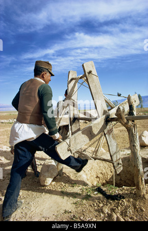 Man using a winding machine to get water from well kanat qanat irrigation system Gashgai Iran Middle East Stock Photo