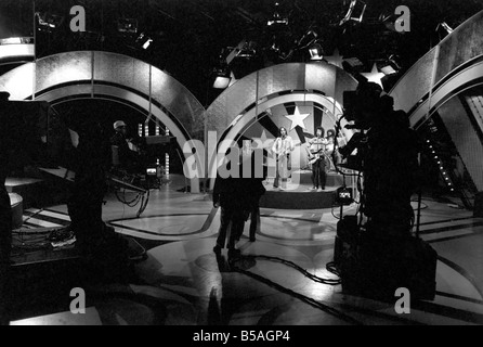 Filming of the television music chart show Top of the Pops at the BBC Studios. Pop group 10cc performing on stage April 1975 Stock Photo