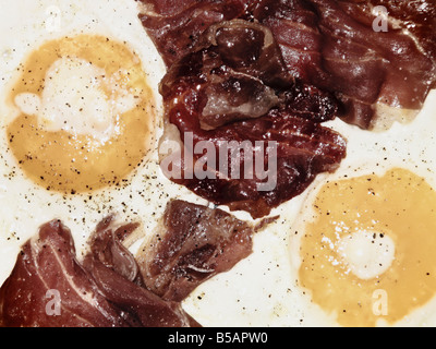 Two Eggs And Bacon In Frying Pan Stock Photo