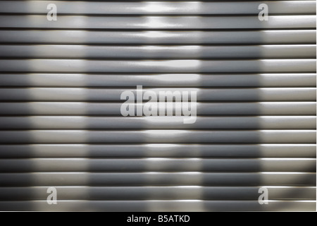 silvery horizontal lines and vertical shadows Plastic white blinds texture Stock Photo