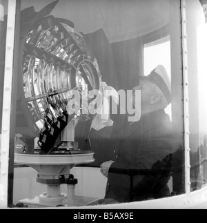 The lighthouse keepers and their families go about their daily duties around The Strathy Point Lighthouse. These include cleaning the lamp, maintaining the foghorn and looking after the garden. 1960 A797-001 Stock Photo