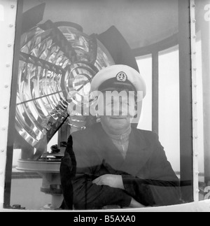 The lighthouse keepers and their families go about their daily duties around The Strathy Point Lighthouse. These include cleaning the lamp, maintaining the foghorn and looking after the garden. 1960 A797-006 Stock Photo