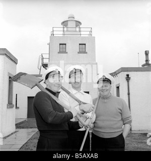 The lighthouse keepers and their families go about their daily duties around The Strathy Point Lighthouse. These include cleaning the lamp, maintaining the foghorn and looking after the garden. 1960 A797-013 Stock Photo