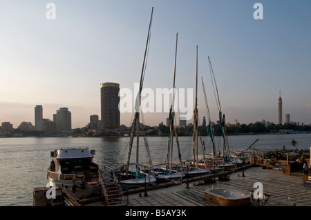 felucca traditional wooden sailing boats moored on the Nile river in front of Gezira Island in the Zamalek district, central Cairo Egypt Stock Photo