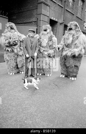 The Yeti Mark two - seven foot tall monsters with light eyes, electrical nervous system, electronic roars, and assisted by a fungoid mist have taken over London for the TV series Dr Who. The yeti's are played by actors Gordon Stothard, John Lord, Colin Warman and John Levene, wearing suits made from Yak fur and wool with eyes that light up.;Our Picture Shows: An anxious moment for a jack russsell dog when he meets up with the Yeti's near Goodge Street underground station in London. Dec 1967;X11800 Stock Photo