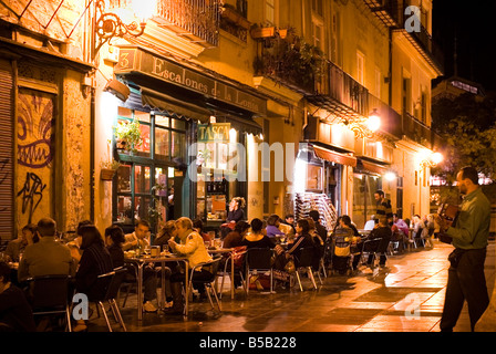 People sitting outside the cafe tapas bar Escalones de la Lonja in the historic El Carmen city centre of Valencia Spain Stock Photo
