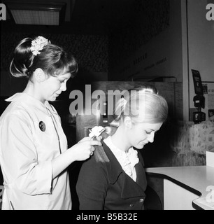 Woman at the beauty department of Selfridges store having a Tovar- tress attached to her hair. 1966 Stock Photo
