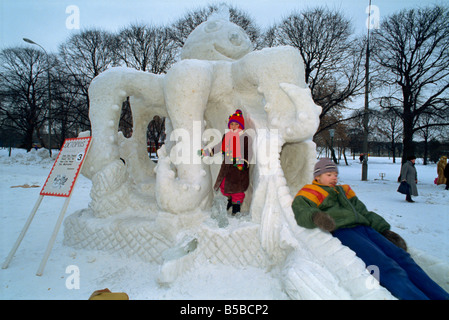 Children play on an octopus ice sculpture during the Ice Sculpture Festival in Gorky Park in Moscow Russia Europe Stock Photo