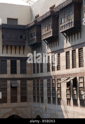 Egyptian style Mashrabiya oriel windows enclosed with carved wood latticework inside the Khanqah of Sultan Al-Ghuri Complex in old Cairo Egypt Stock Photo