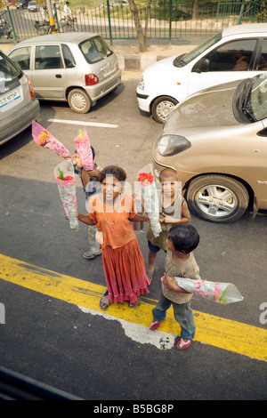 Poor children on the steets of Delhi selling flowers to make money; New Delhi, India Stock Photo