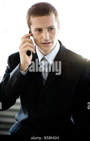 30 year old caucasian male in a business suit using a cellular Stock Photo